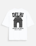 Abackside of white short-sleeve t-shirt with a black graphic print of the India Gate monument in Delhi, featuring the text 'DELHI' at the top and 'HEART OF INDIA DELHI - INDIA' at the bottom back .streetware