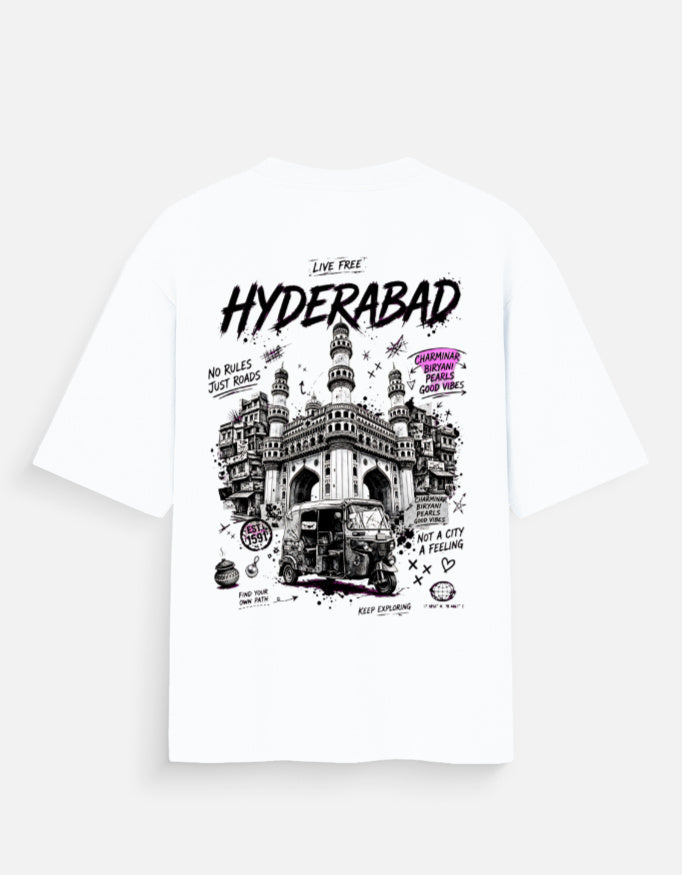 White short-sleeve T-shirt shown flat against a light gray background, featuring a large black and white illustrated graphic of Hyderabad with the word 'HYDERABAD' in bold black letters and smaller black text and doodles.