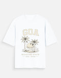 A white short-sleeve t-shirt with a vintage-style graphic on the front featuring the word 'GOA' in beige, two palm trees, a sun, and the text 'SUNSHINE STATE GOA INDIA'.