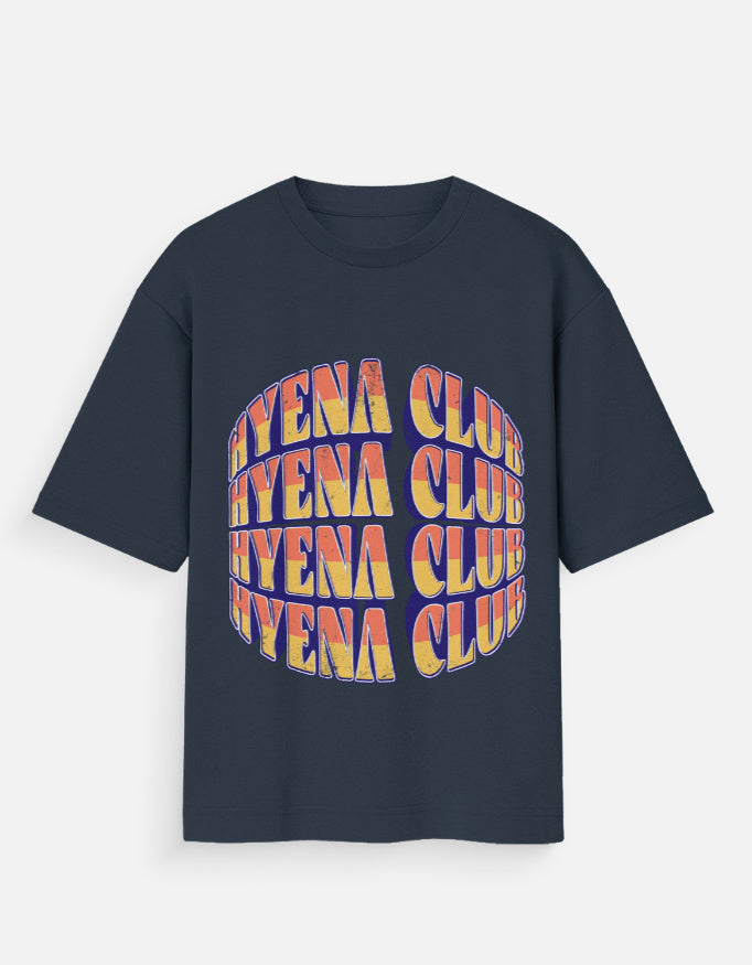A navy blue short-sleeve t-shirt with a large graphic on the front featuring the text 'HYENA CLUB' repeated in a 3D-effect font with yellow, orange, and red colors, set against a light gray background.